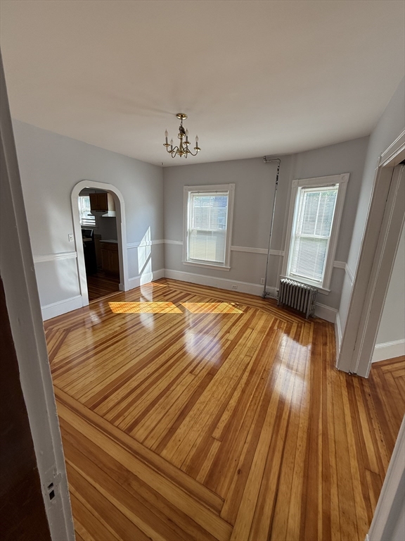 a view of a living room hardwood and kitchen