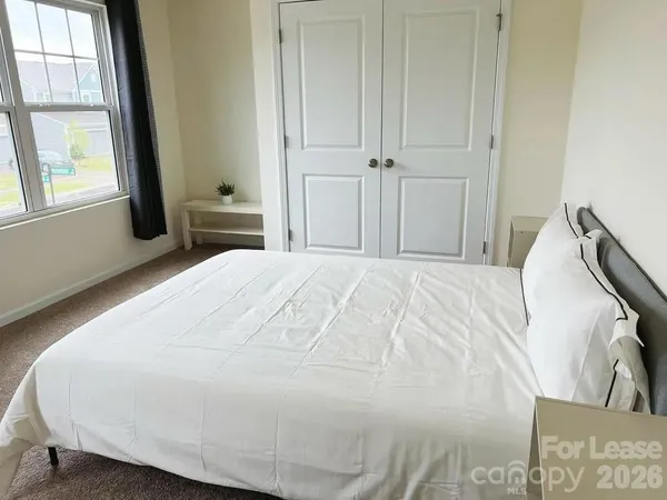 a large white bed in a white room