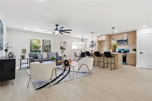 a living room with furniture and kitchen view