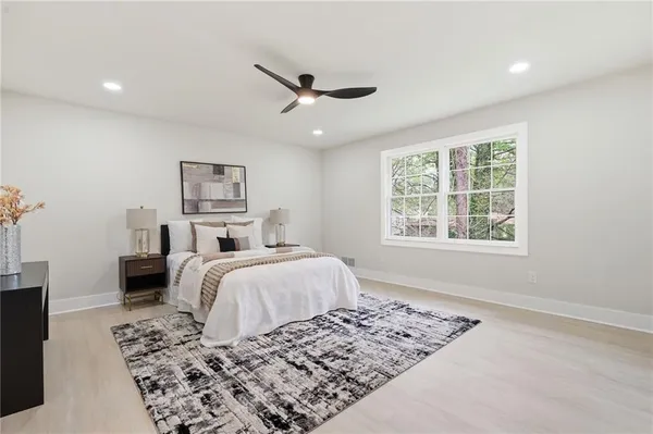 a bedroom with a bed and wooden floor