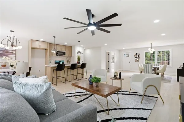 a living room with furniture and kitchen view
