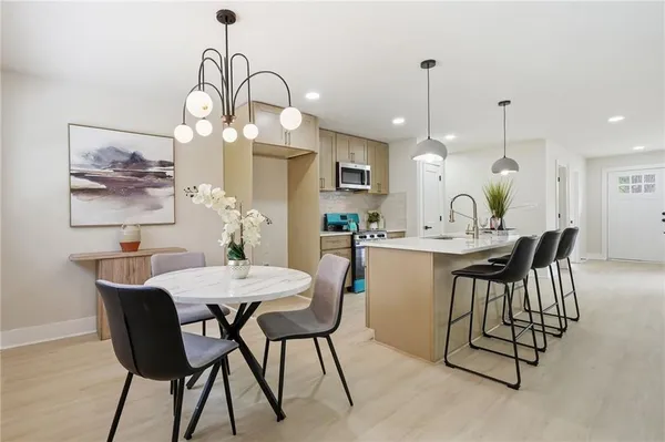 a view of a dining room with furniture and chandelier