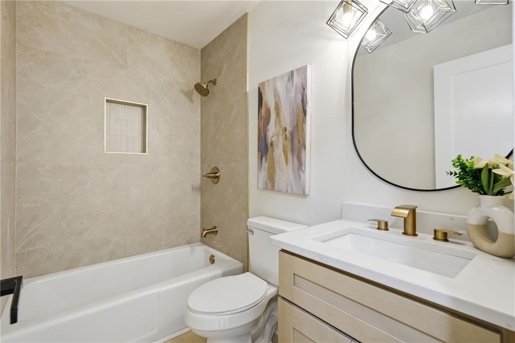4158 Marist Court Decatur, GA 30034 - Photo 8 of 34 a bathroom with a granite countertop sink a toilet and a mirror