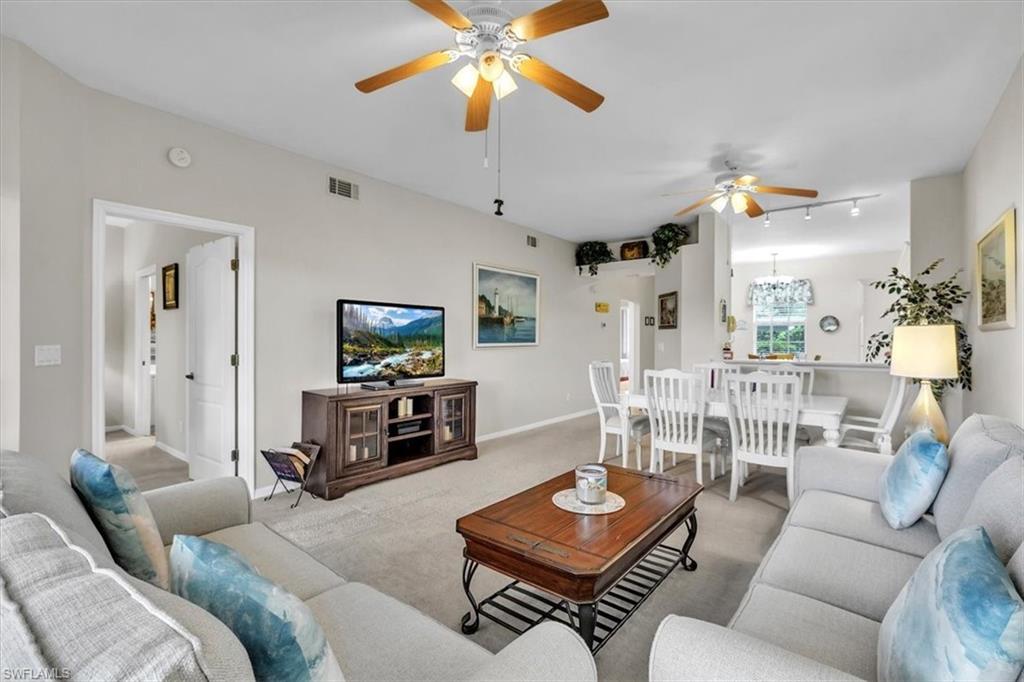 8075 Tiger Cove, Unit 1706 Naples, FL 34113 - Photo 6 of 50 Living area with a ceiling fan and carpet flooring