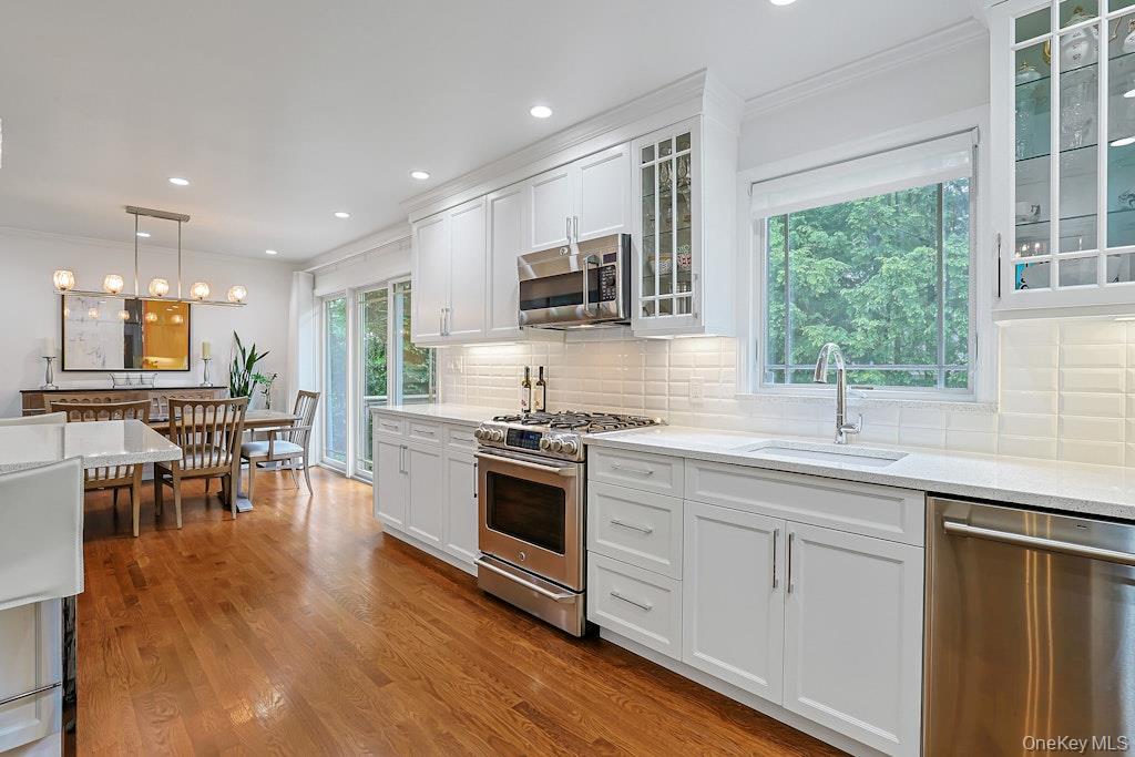 305 Stratton Road New Rochelle, NY 10804 - Photo 4 of 32 a kitchen with stainless steel appliances granite countertop a stove and a sink