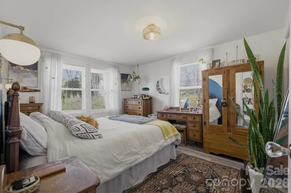 a bedroom with a bed next to a window with the outer view