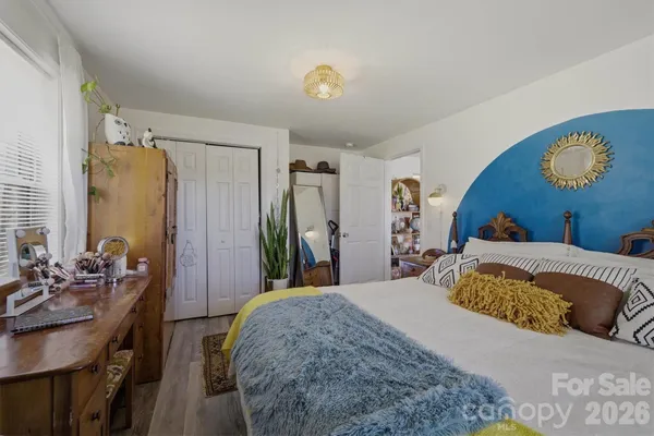 a bedroom with a bed and dresser