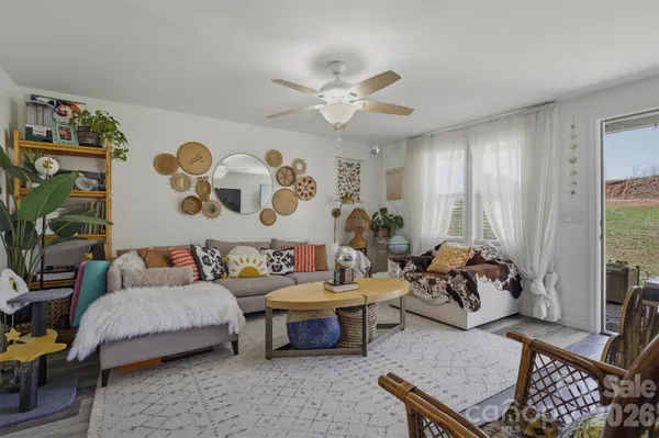 a living room with furniture and wooden floor