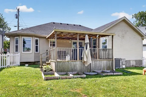 a front view of a house with a yard table and chairs