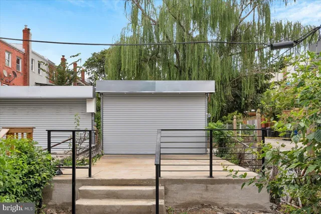 a view of a brick house with potted plants