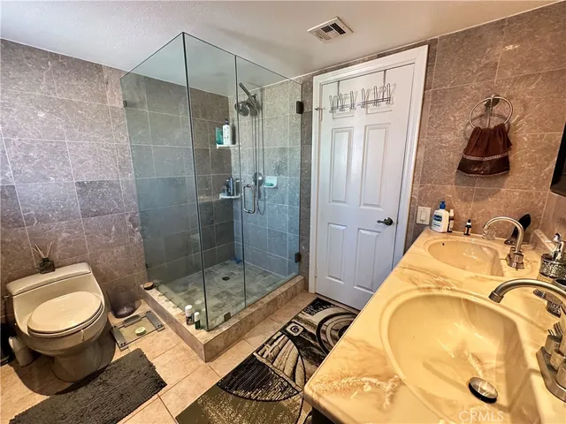 a bathroom with a toilet and a shower