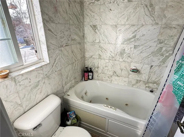 a bathroom with a bathtub and window