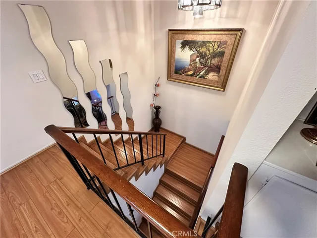 a view of staircase with furniture and lots of frames on wall