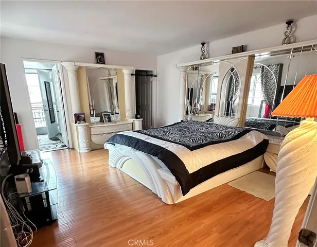 a bedroom with a bed next to a window