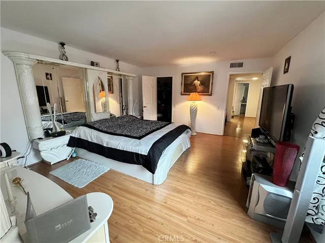 a bedroom with a bed window and a flat screen television