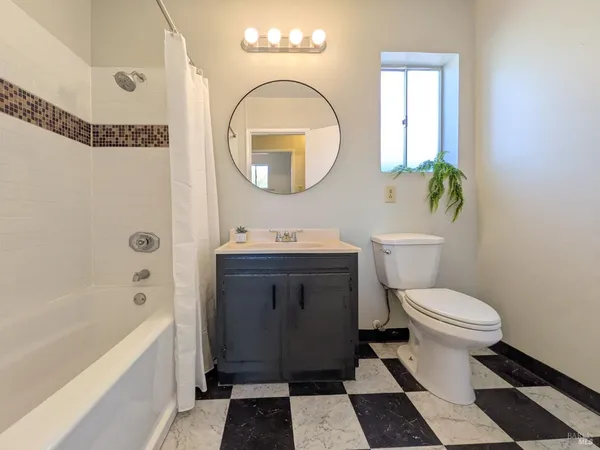 a bathroom with a toilet a sink and a mirror