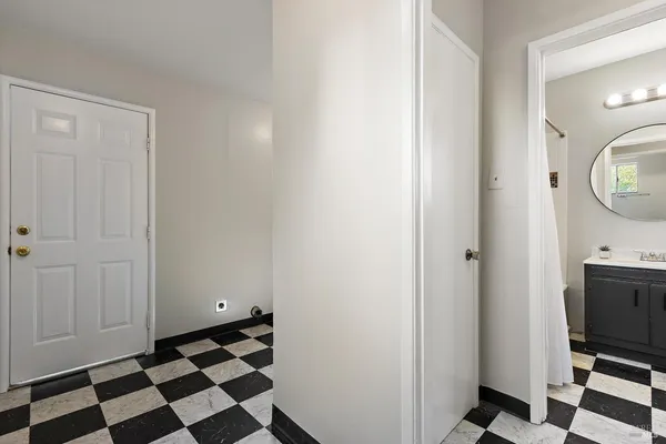 a city view with a black white checkered floor and a mirror
