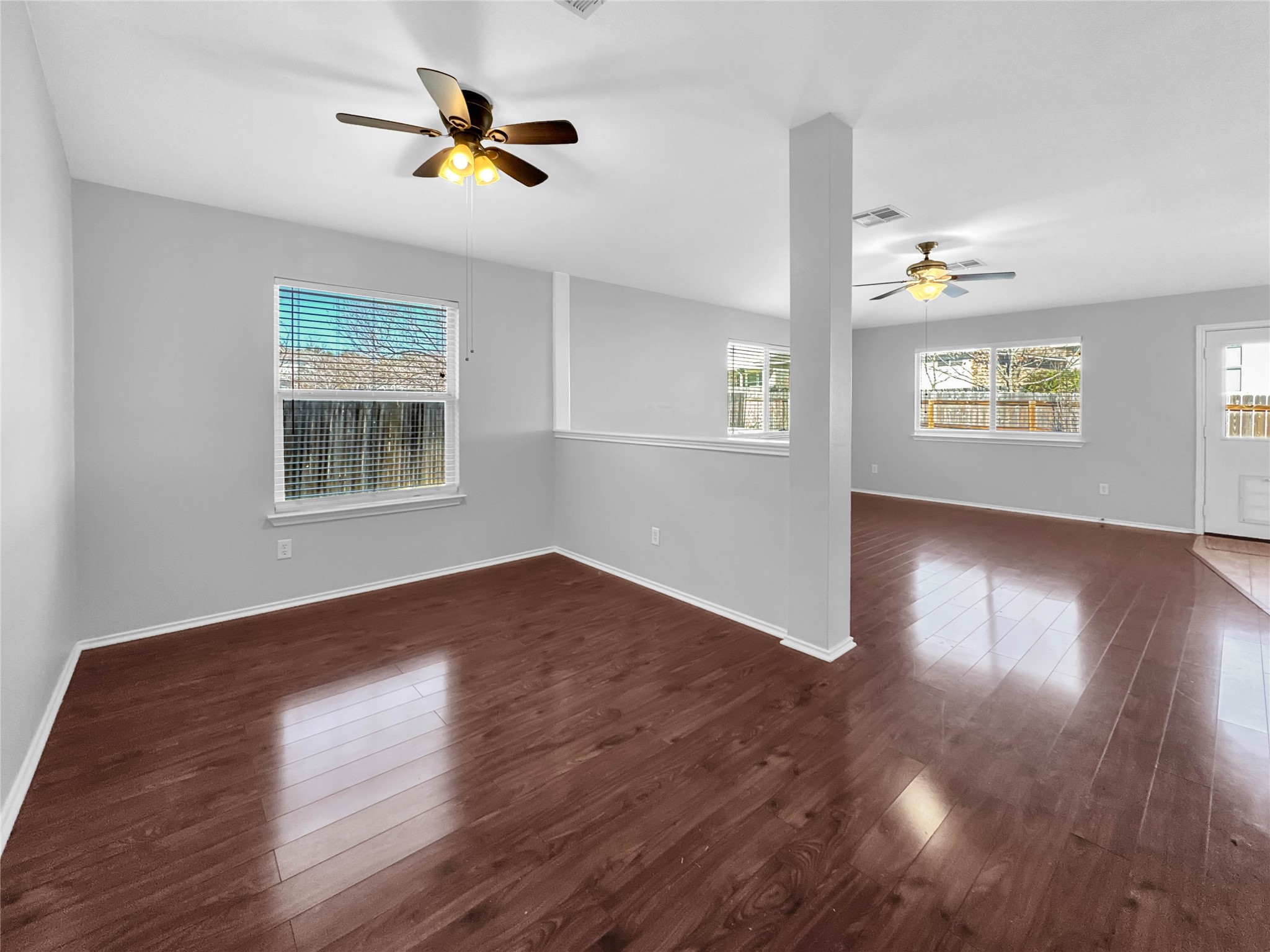 1032 Tudor House Road Pflugerville, TX 78660 - Photo 11 of 32 a view of an empty room with wooden floor and a window