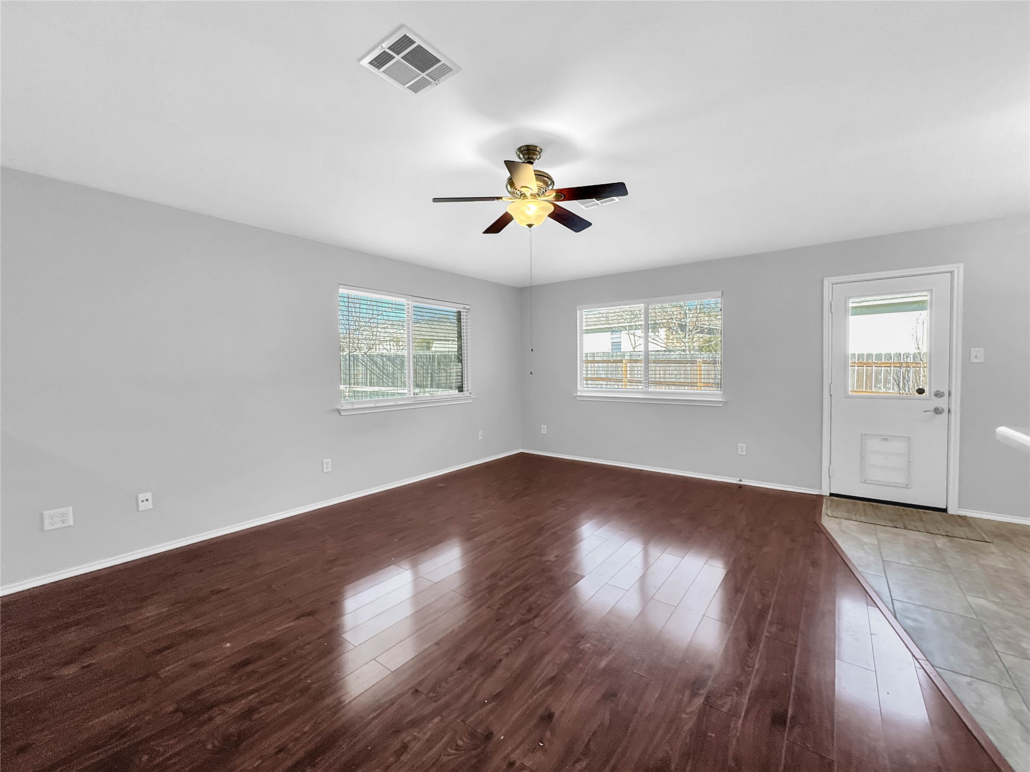 1032 Tudor House Road Pflugerville, TX 78660 - Photo 15 of 32 a view of an empty room with wooden floor and a window