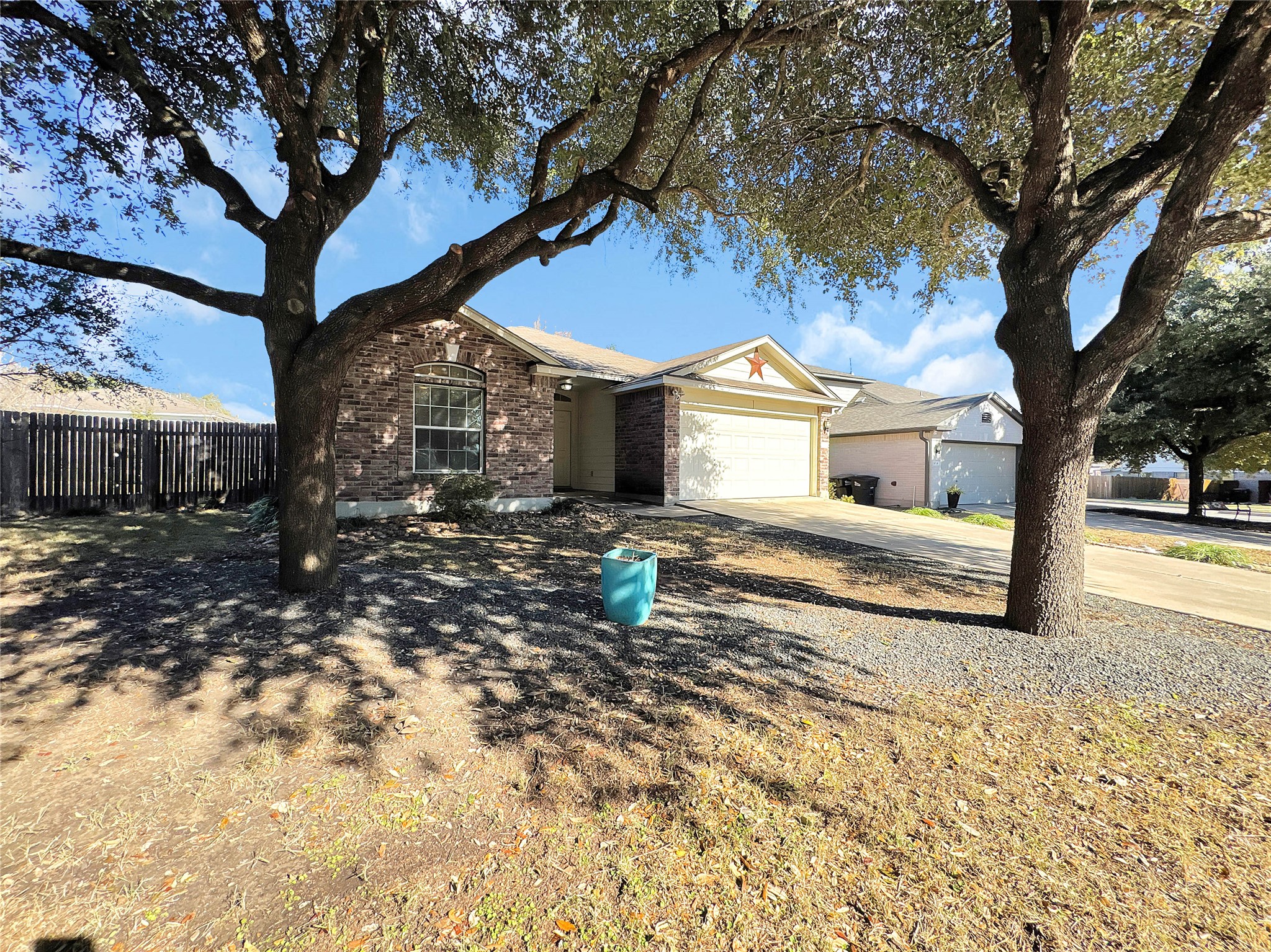 1032 Tudor House Road Pflugerville, TX 78660 - Photo 2 of 32 a front view of a house with a yard