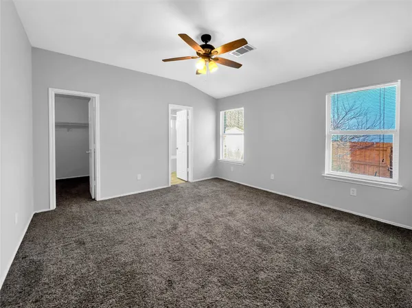 a view of a livingroom with a ceiling fan and window