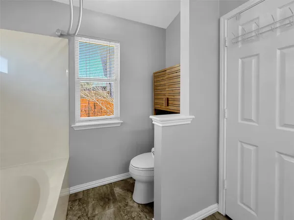 a bathroom with a toilet sink and shower