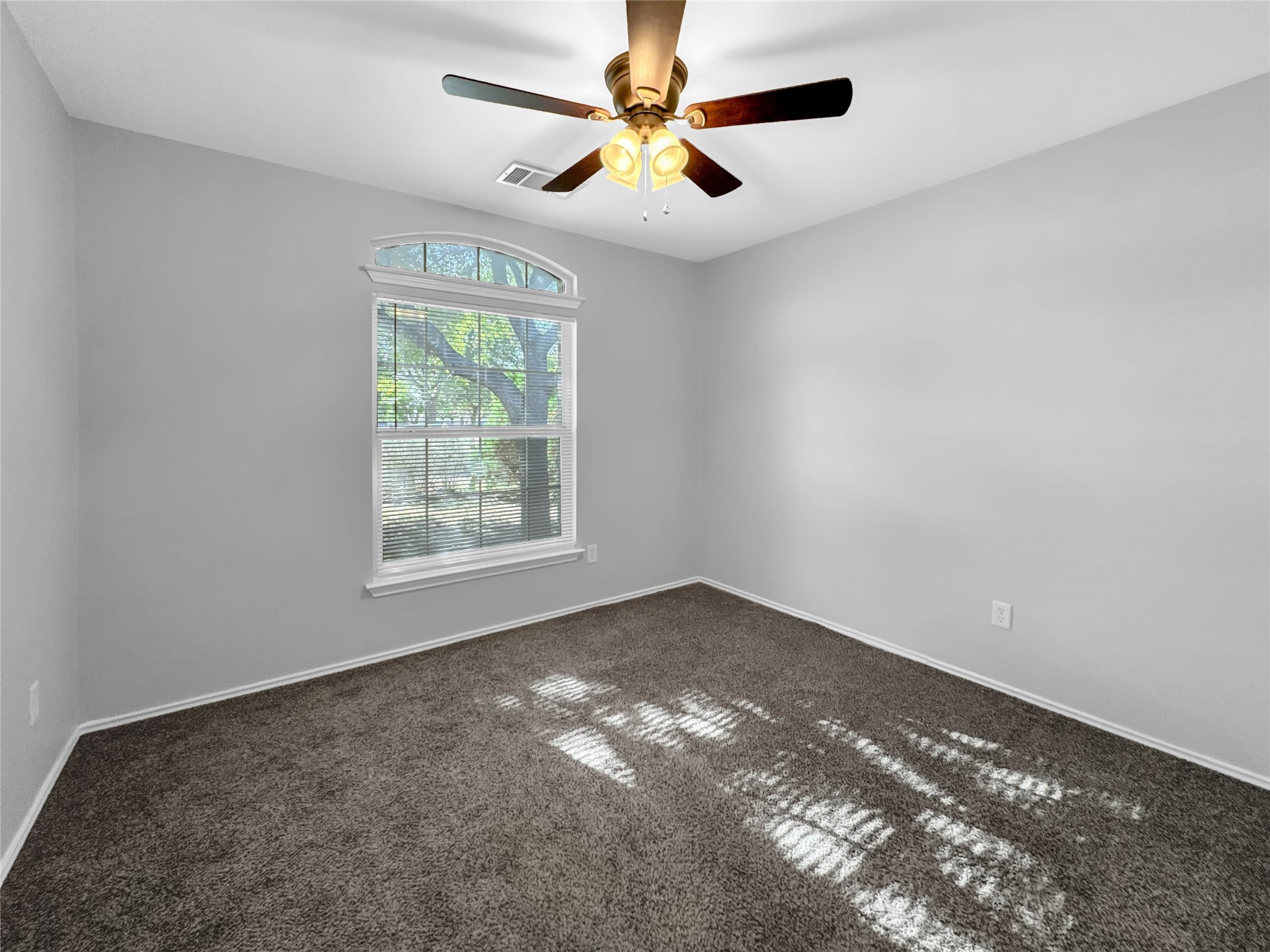 1032 Tudor House Road Pflugerville, TX 78660 - Photo 29 of 32 a view of an empty room with window and chandelier fan