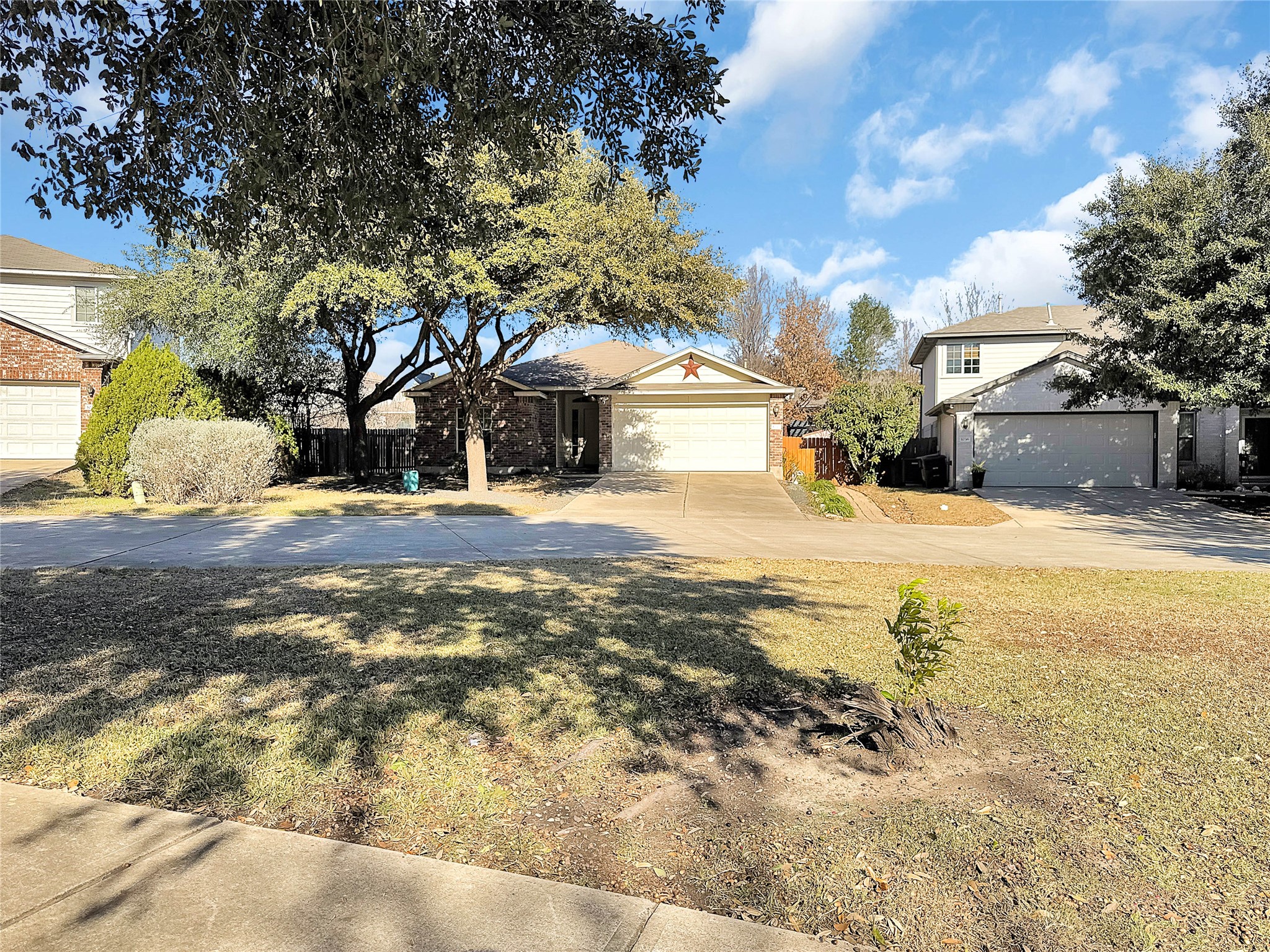 1032 Tudor House Road Pflugerville, TX 78660 - Photo 5 of 32 a view of a yard with a large tree in front of the house