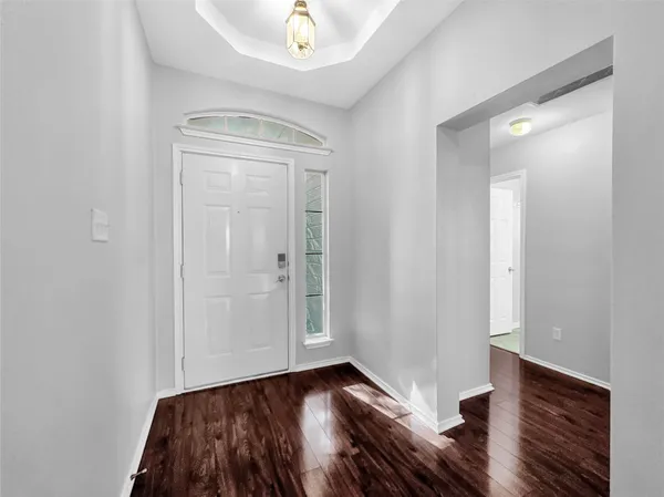 a view of hallway with wooden floor
