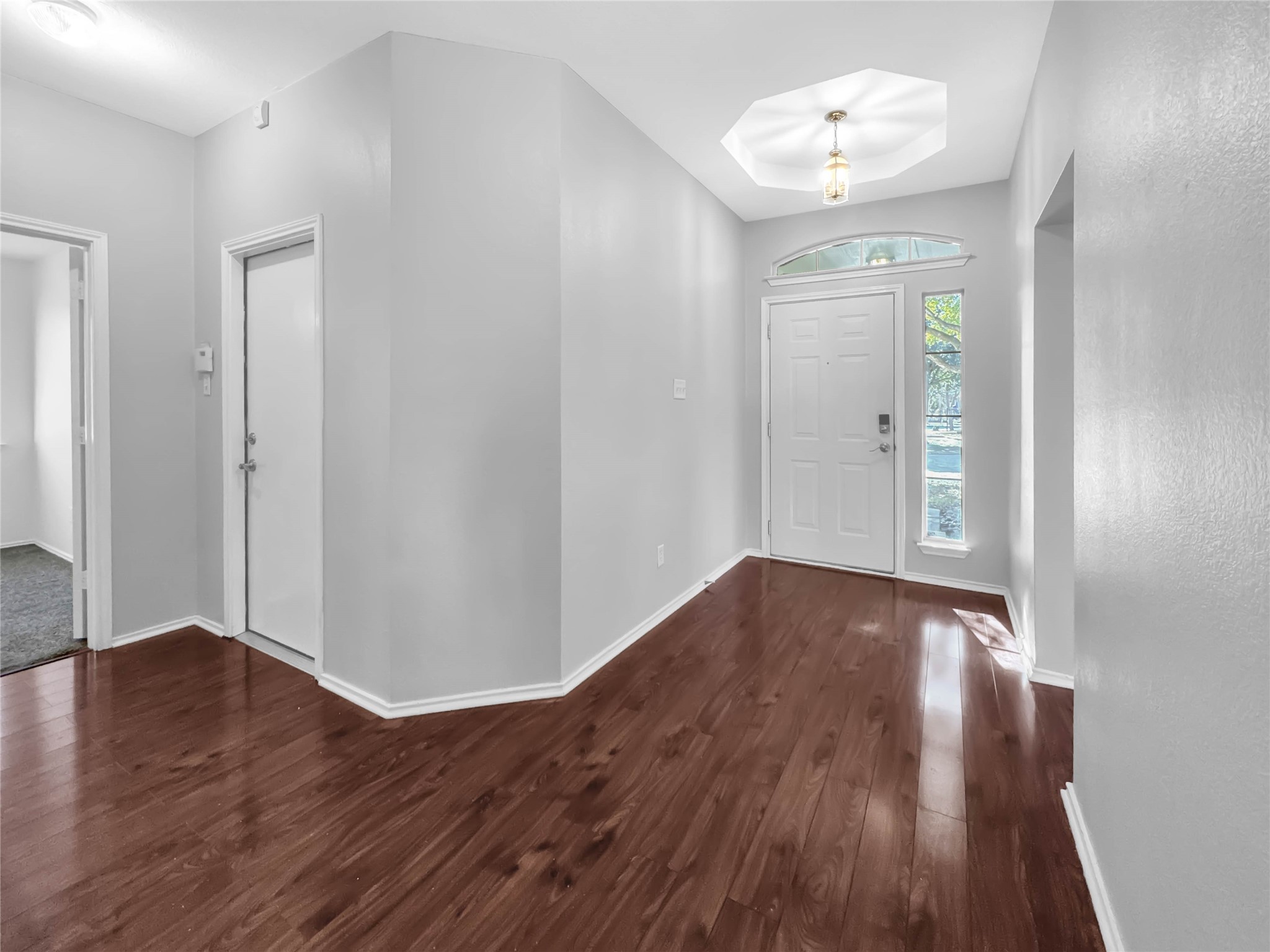 1032 Tudor House Road Pflugerville, TX 78660 - Photo 8 of 32 a view of a hallway with wooden floor