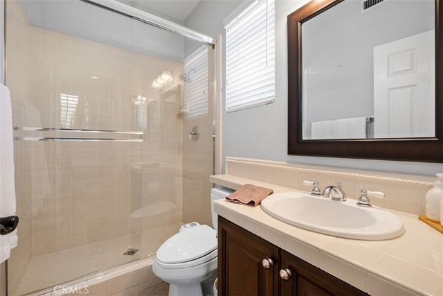 a bathroom with a sink toilet a mirror and shower