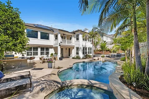 a view of a house with swimming pool and sitting area