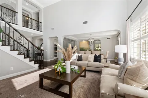 a living room with furniture and a chandelier