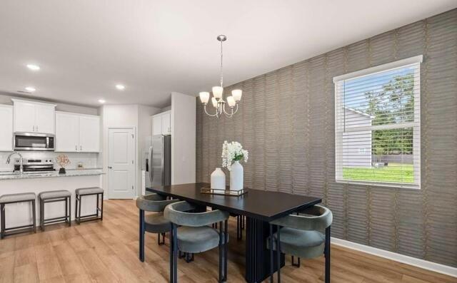 1260 Riverstone Road Jonesboro, GA 30236 - Photo 15 of 45 a view of a dining room with furniture window and wooden floor