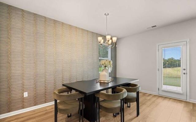 1260 Riverstone Road Jonesboro, GA 30236 - Photo 18 of 45 a view of a dining room with furniture and wooden floor