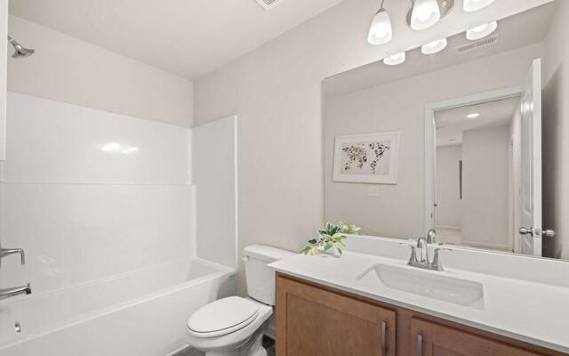 1260 Riverstone Road Jonesboro, GA 30236 - Photo 19 of 45 a bathroom with a sink a toilet and a bathtub
