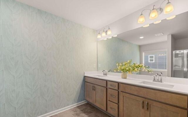 1260 Riverstone Road Jonesboro, GA 30236 - Photo 20 of 45 a bathroom with a double vanity sink and a mirror