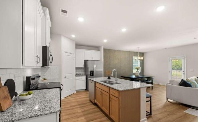 1260 Riverstone Road Jonesboro, GA 30236 - Photo 7 of 45 a kitchen with stainless steel appliances granite countertop a sink a stove and a refrigerator