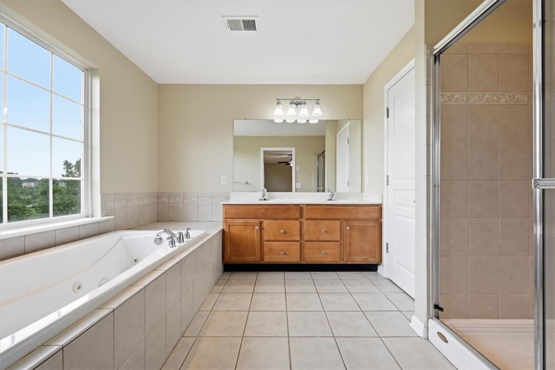 8761 Cascade Road Breinigsville, PA 18031 - Photo 46 of 84 Luxurious bathroom retreat features a spacious soaking tub, separate shower, and a generous vanity with dual sinks.