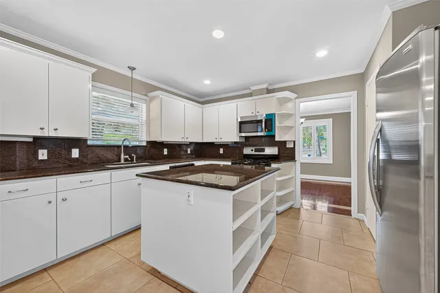 a kitchen with stainless steel appliances granite countertop a sink and a stove