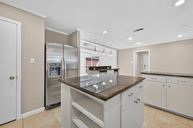 a kitchen with stainless steel appliances granite countertop a refrigerator and a sink