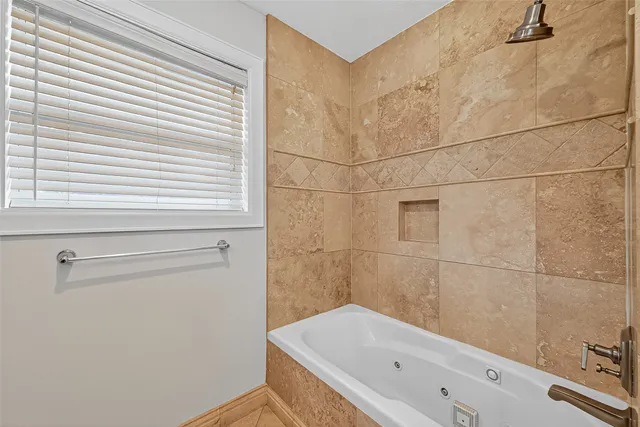 a bathroom with a bathtub and shower