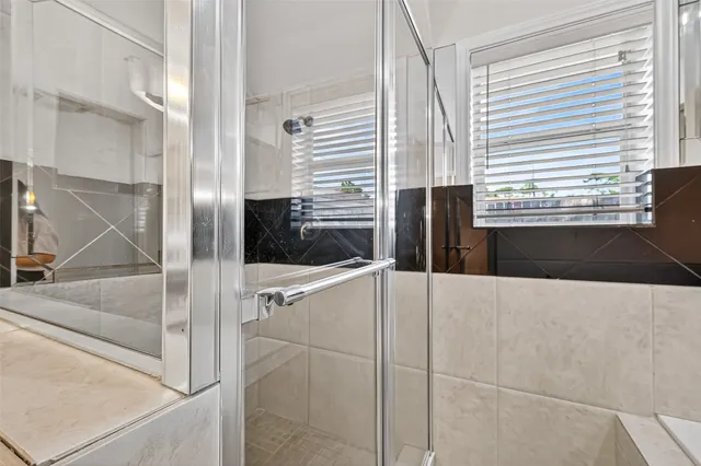 a bathroom with a tub and shower