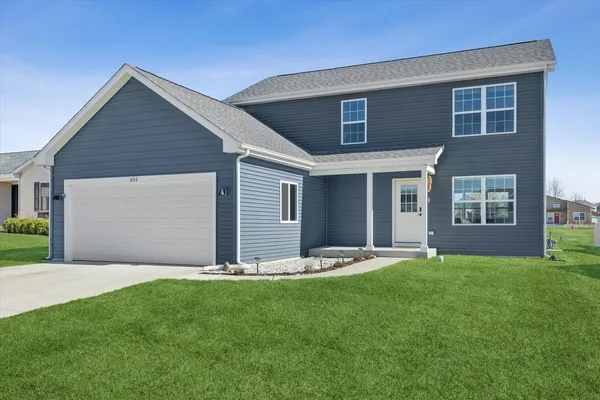 a front view of house with yard and green space