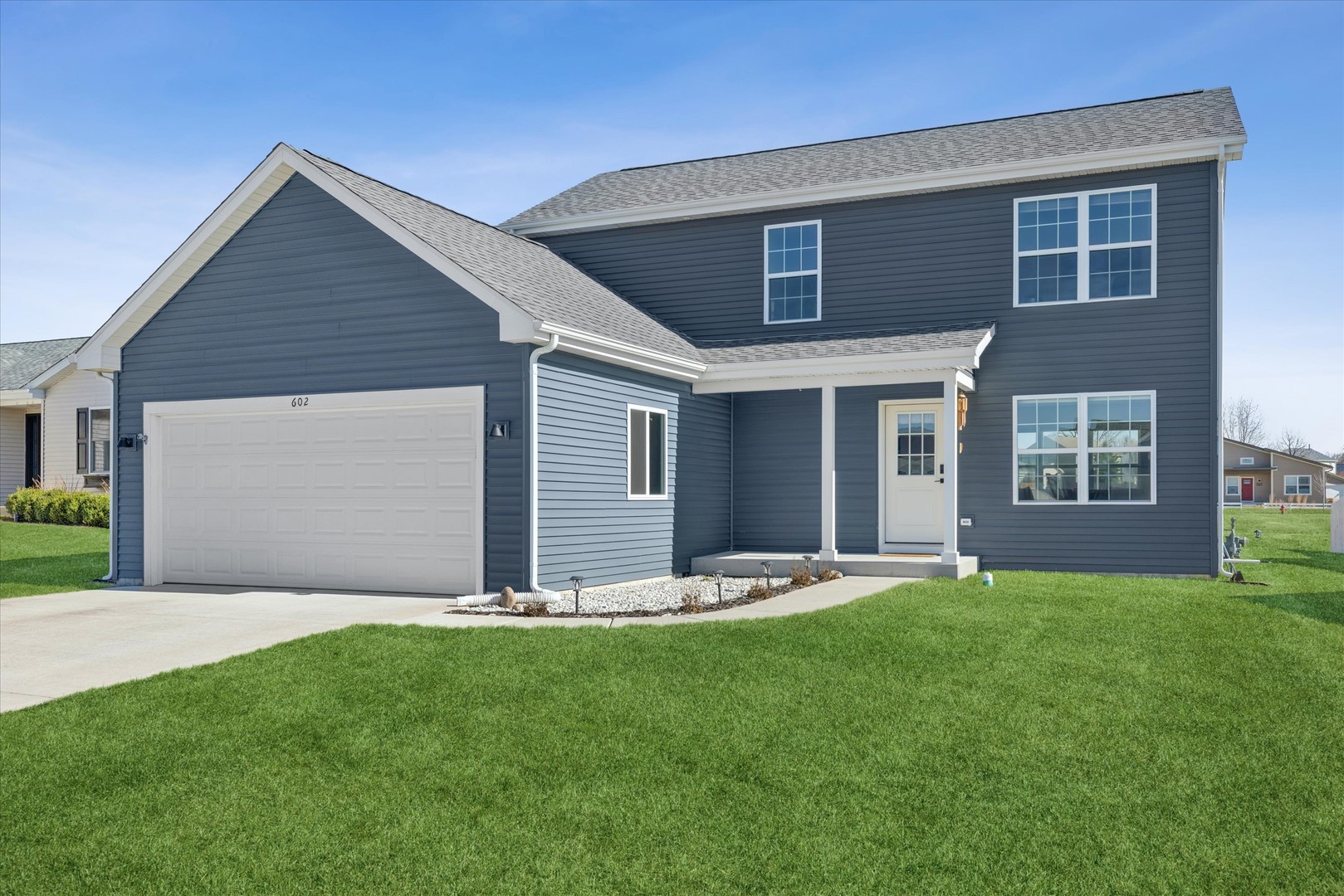 a front view of house with yard and green space