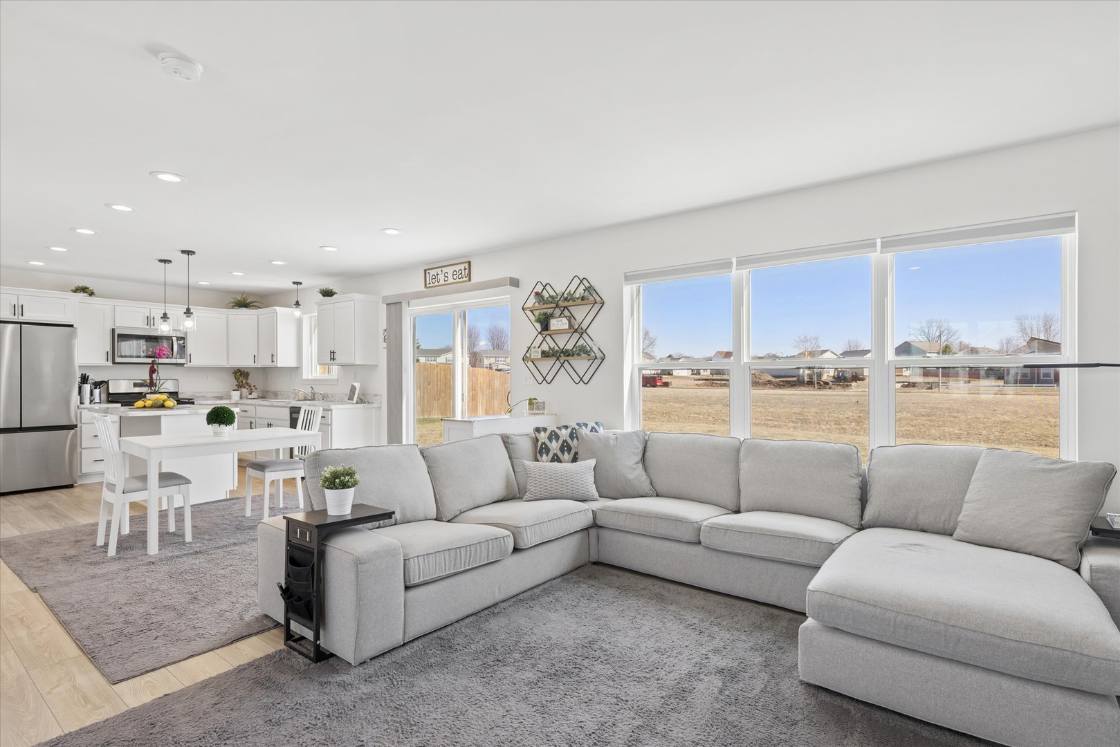 602 Apple Valley Road Harvard, IL 60033 - Photo 4 of 24 a living room with furniture white walls and a view of kitchen