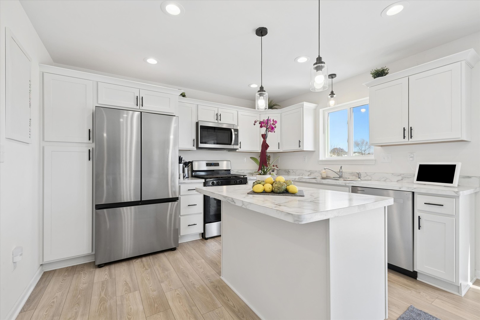 602 Apple Valley Road Harvard, IL 60033 - Photo 5 of 24 a kitchen with a refrigerator a white cabinets and wooden floor