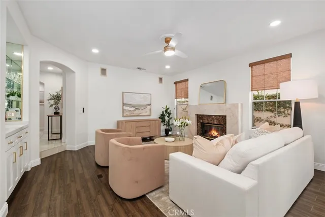 a living room with furniture a fireplace and a potted plant