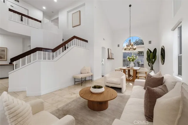 a living room with furniture and a floor to ceiling window