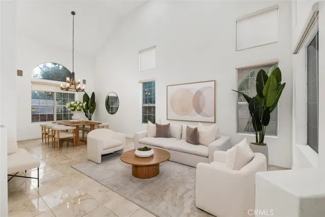 a living room with furniture a lamp a rug and a window